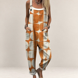 Valvet Oak House loose-fit jumpsuit in orange and white geometric print with adjustable straps and side pockets