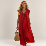 Valvet Oak House red linen-blend maxi dress with ruffle details and side pockets worn by a woman in a Greek village