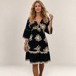 Valvet Oak House Hestia boho dress in black with cream floral embroidery, featuring a V-neck and flared sleeves.