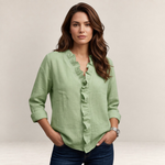 Valvet Oak House Elaine sage green blouse with V-neck ruffles and three-quarter sleeves worn by a woman with jeans.