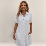 Valvet Oak House white button-down shirt dress with short sleeves and pockets worn by a smiling woman