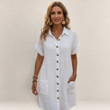 Valvet Oak House white button-down shirt dress with short sleeves and pockets worn by a smiling woman