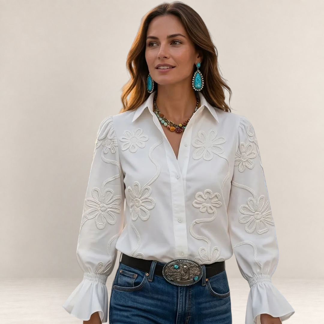 Valvet Oak House Ariane white blouse with raised floral embroidery, long bell sleeves, and a classic collar.