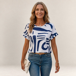 Valvet Oak House Ismene t-shirt with a white and blue abstract print, round neckline, and short sleeves on a model.