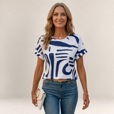 Valvet Oak House Ismene t-shirt with a white and blue abstract print, round neckline, and short sleeves on a model.