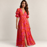 Valvet Oak House Elena maxi dress in pink and orange floral print with deep V-neck, puff sleeves, and front slit.