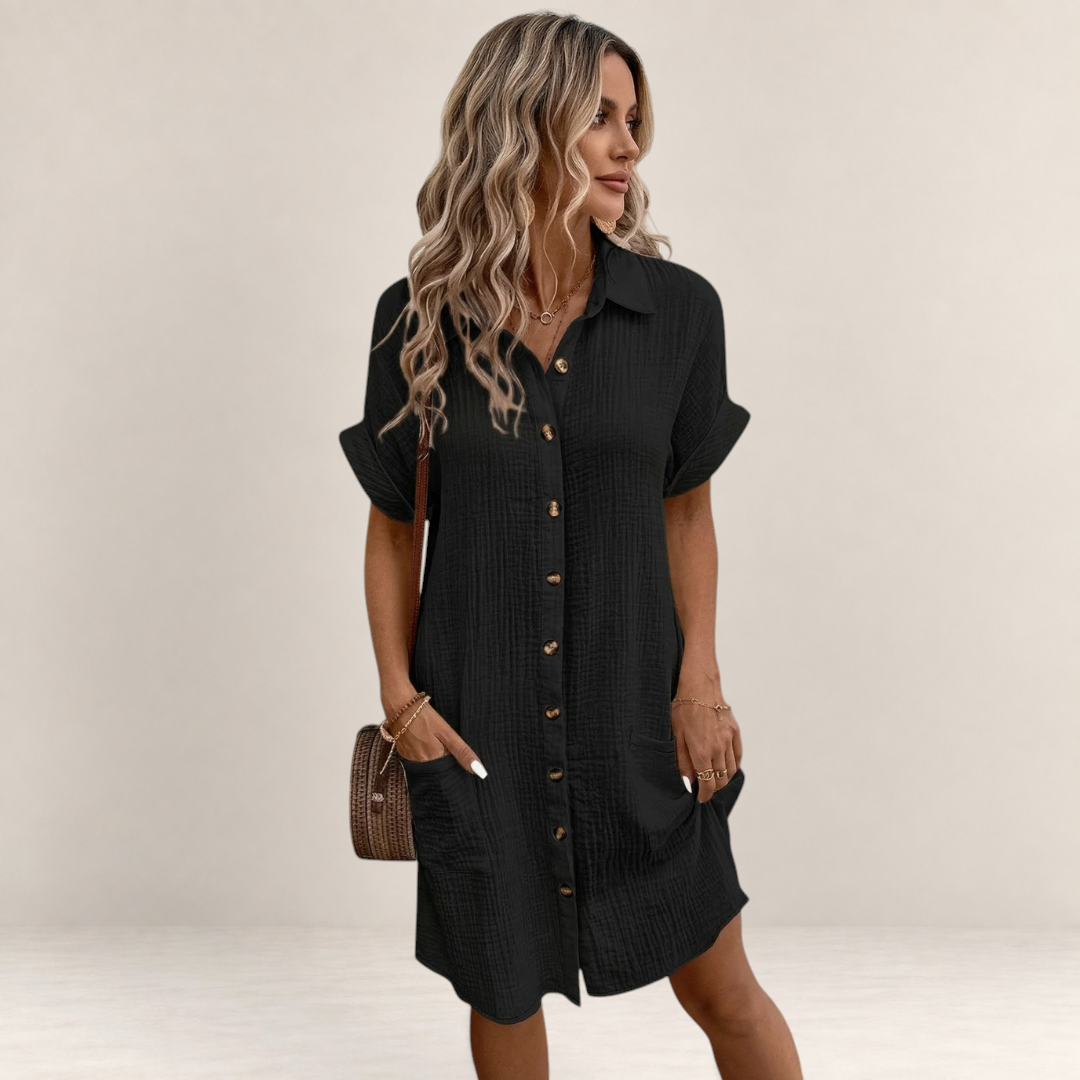 Valvet Oak House black button-down shirt dress with short sleeves and pockets, worn by a woman on a cobblestone street