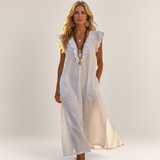 Valvet Oak House white linen-blend maxi dress with ruffled V-neck and side pockets worn by a blonde model