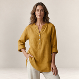 Valvet Oak House Edna mustard yellow linen-blend blouse with a V-neck and button placket worn by a woman.