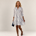Valvet Oak House Theia white shirt dress with blue wavy line pattern, featuring a flattering A-line silhouette.