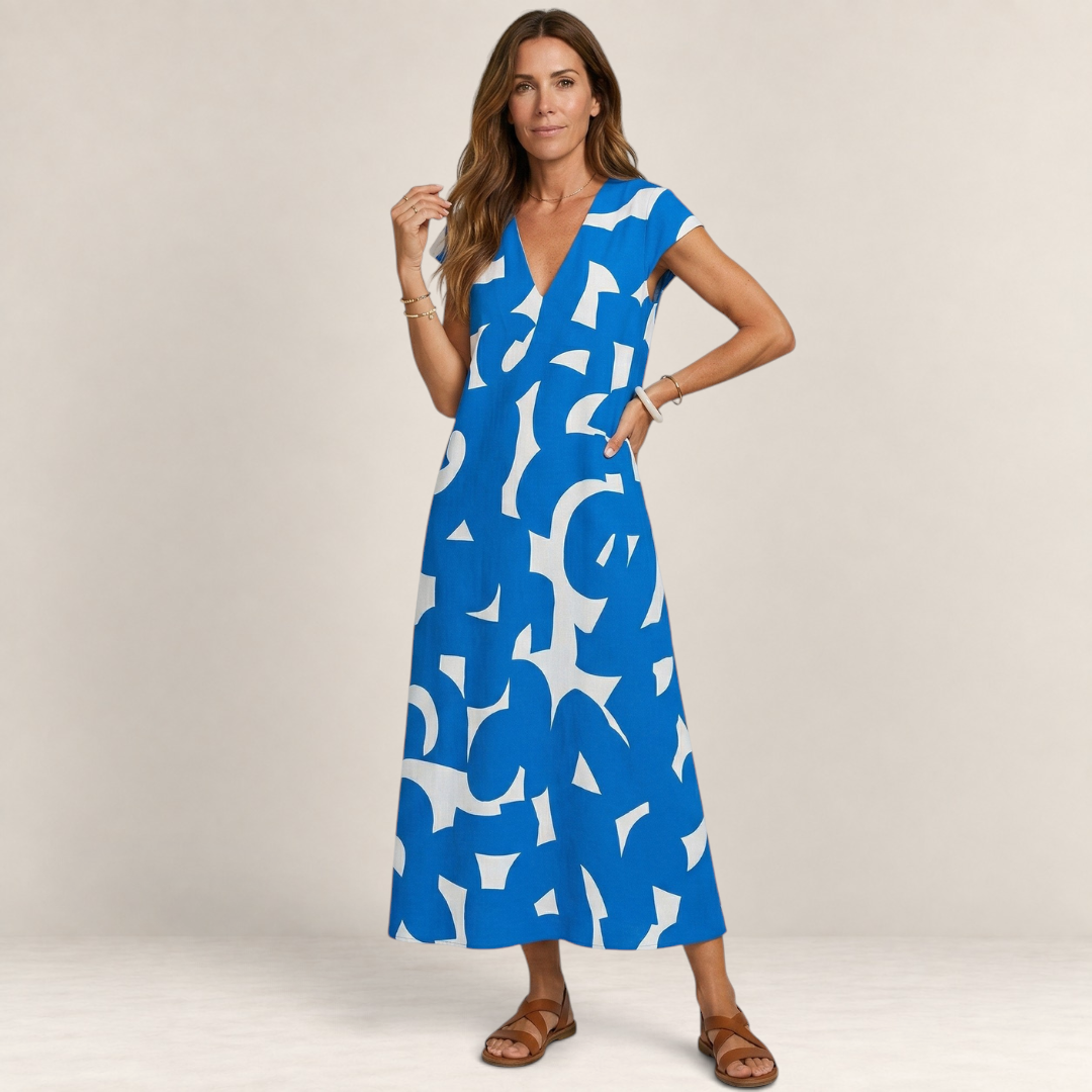 Valvet Oak House Thetis midi dress in blue and white with a V-neck and abstract print worn by a woman