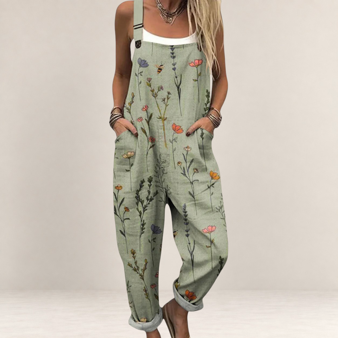Valvet Oak House sage green floral print jumpsuit with wide legs, adjustable straps, and side pockets on a model