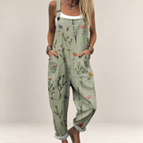 Valvet Oak House sage green floral print jumpsuit with wide legs, adjustable straps, and side pockets on a model