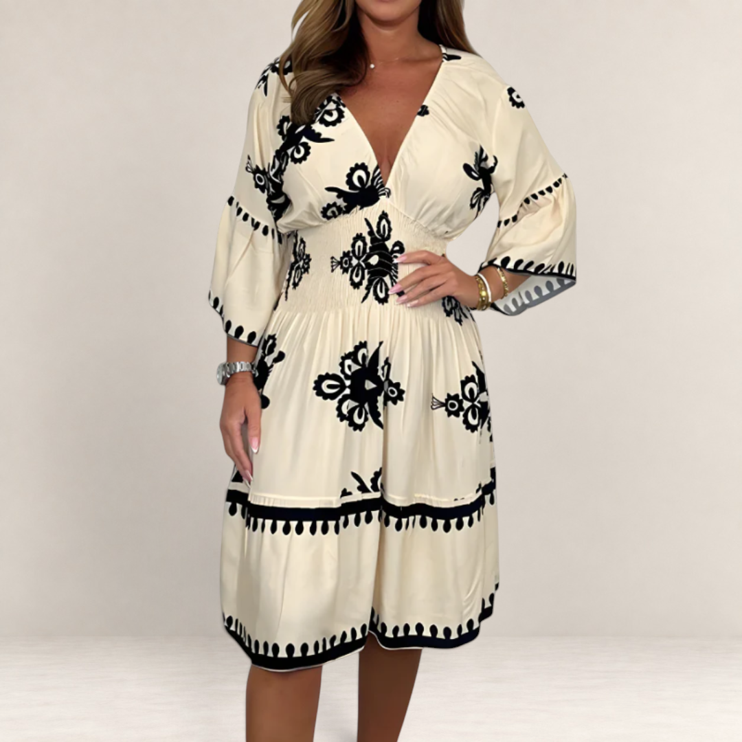 Valvet Oak House Hestia boho midi dress in cream with black floral embroidery, V-neck, and cinched waist.
