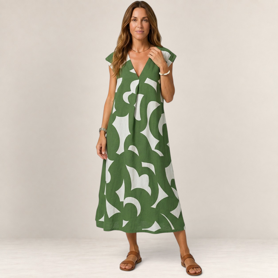 Valvet Oak House Thetis midi dress in green and white abstract print with V-neckline worn by a woman