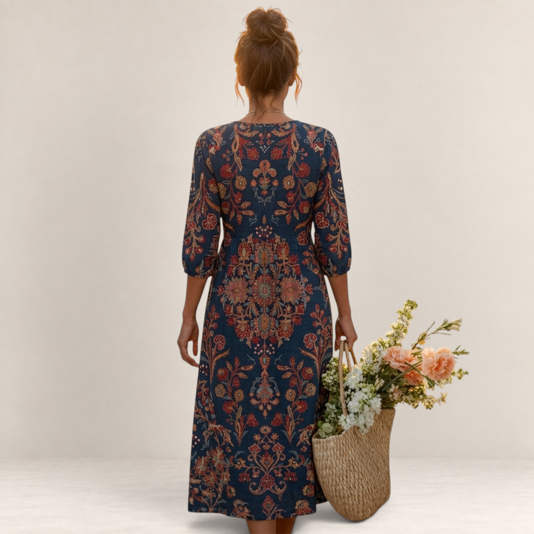 Valvet Oak House Leda long dress with ethnic floral patterns, V-neck, and three-quarter sleeves, worn by a woman.