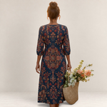 Valvet Oak House Leda long dress with ethnic floral patterns, V-neck, and three-quarter sleeves, worn by a woman.