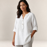 Valvet Oak House white linen-blend blouse with a V-neck and button placket worn by a woman with dark wavy hair.
