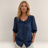Valvet Oak House Marina navy blue floral embroidered blouse with a Peter Pan collar worn by a blonde woman