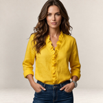 Valvet Oak House Elaine yellow blouse with V-neck ruffles worn by a woman with wavy hair and blue jeans
