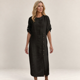Valvet Oak House Helena black midi dress with button details and short sleeves worn by a blonde model