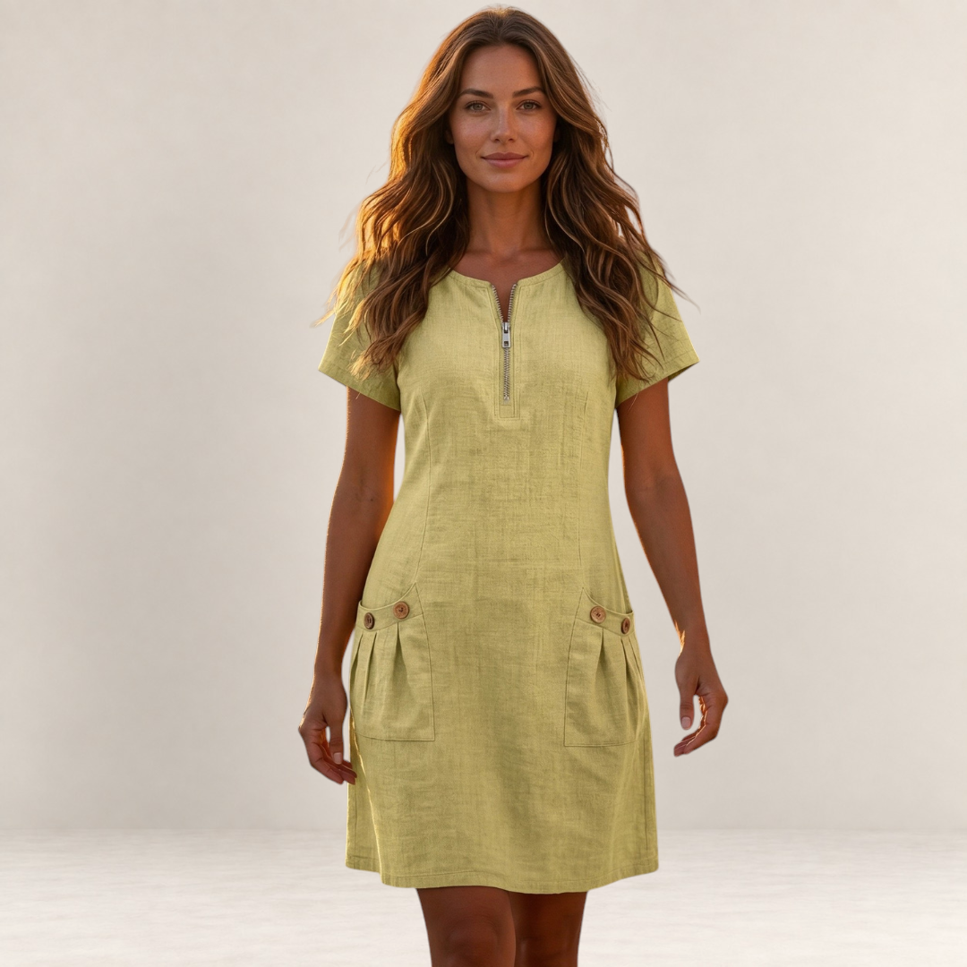Valvet Oak House light yellow cotton-linen A-line dress with front zip and pockets worn by a woman in Greece