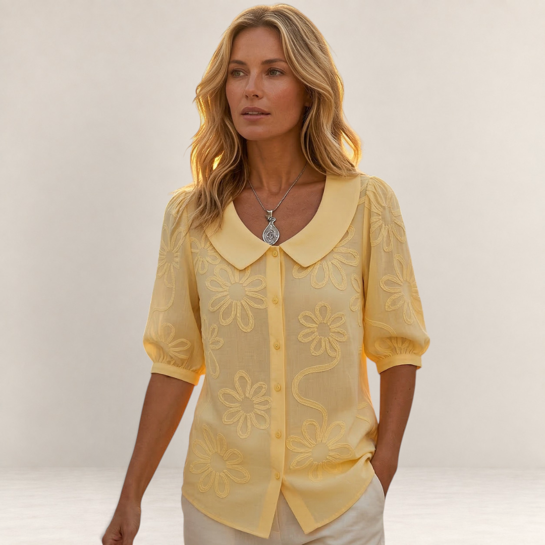 Valvet Oak House Marina yellow floral button-down blouse with a rounded collar worn by a woman