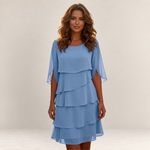 Valvet Oak House Cassandra blue layered dress with flutter sleeves and a flowy silhouette on a woman