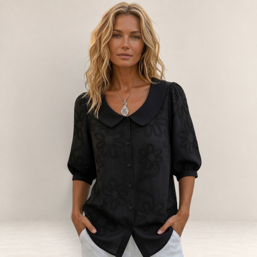 Valvet Oak House black floral embroidered blouse with a peter pan collar worn by a woman with blonde hair