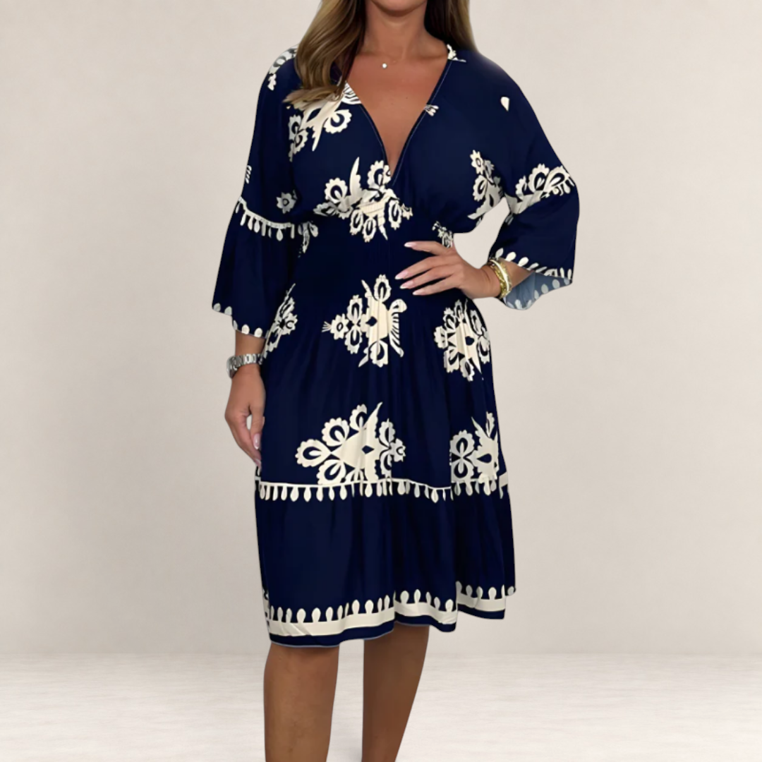 Valvet Oak House Hestia navy blue boho midi dress with white floral embroidery and bell sleeves on a model