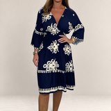 Valvet Oak House Hestia navy blue boho midi dress with white floral embroidery and bell sleeves on a model