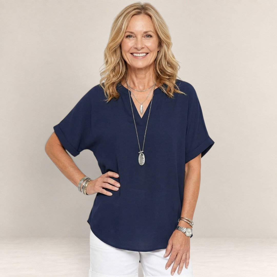 Valvet Oak House navy blue lightweight V-neck top worn by a smiling woman with layered necklaces and bracelets