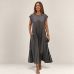 Valvet Oak House grey pleated midi dress with cap sleeves worn by a woman walking on a cobblestone street