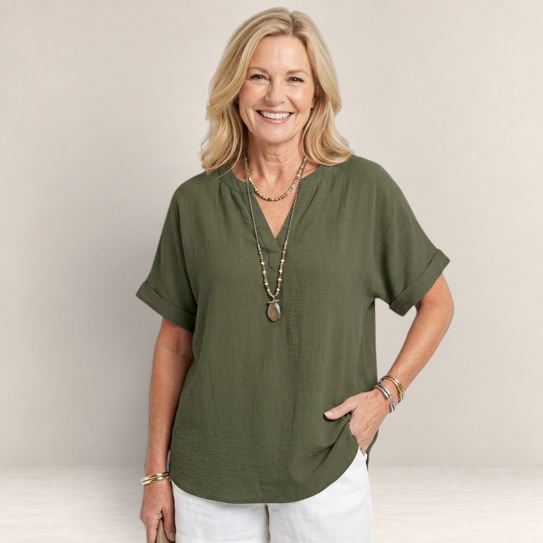Valvet Oak House olive green lightweight V-neck top worn by a smiling woman with layered beaded necklaces