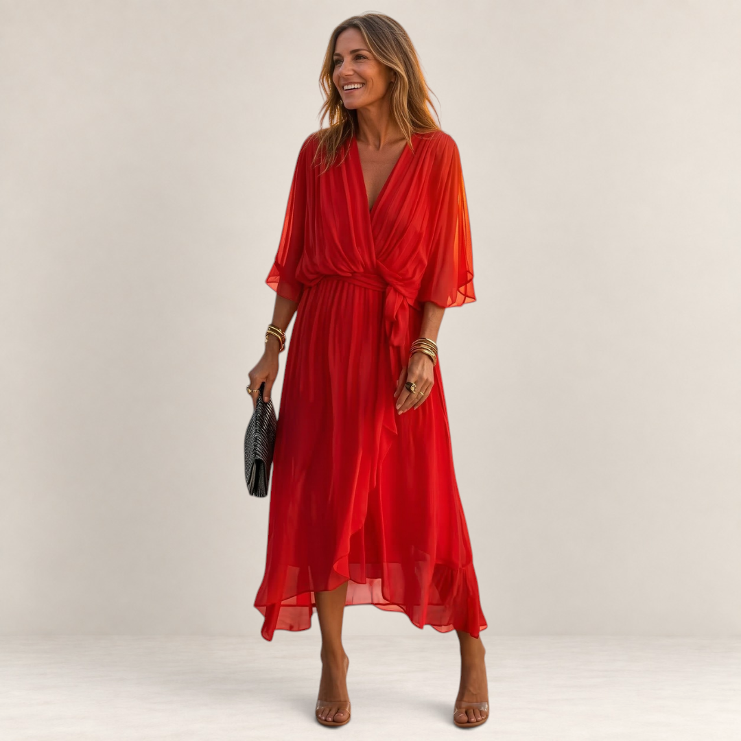 Valvet Oak House red midi dress with V-neck, waist tie, and flowing sleeves worn by a smiling woman