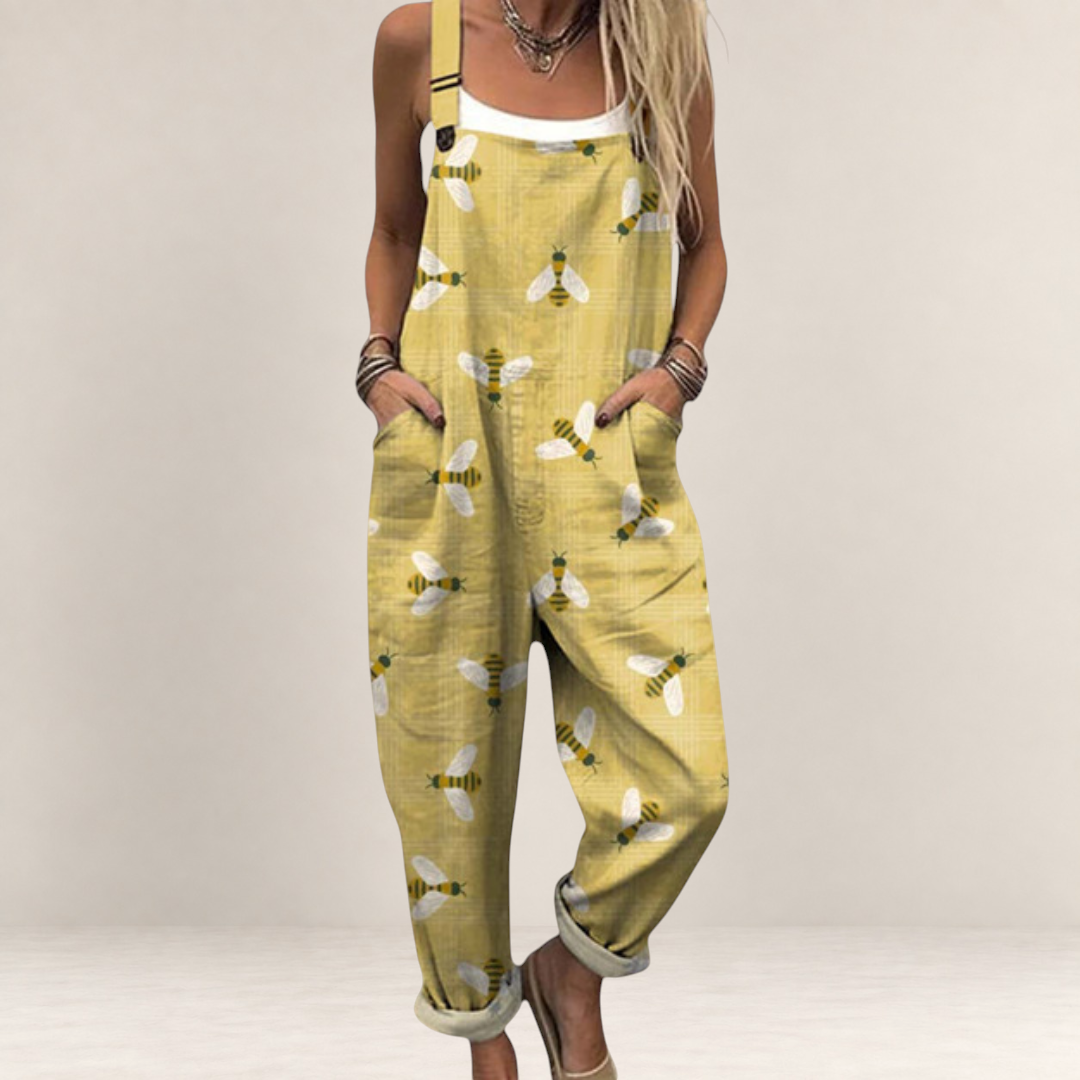 Valvet Oak House yellow printed jumpsuit with bee pattern, featuring wide legs, adjustable straps, and side pockets.
