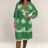 Valvet Oak House Hestia green boho dress with white floral print, V-neckline, and smocked waist on a model