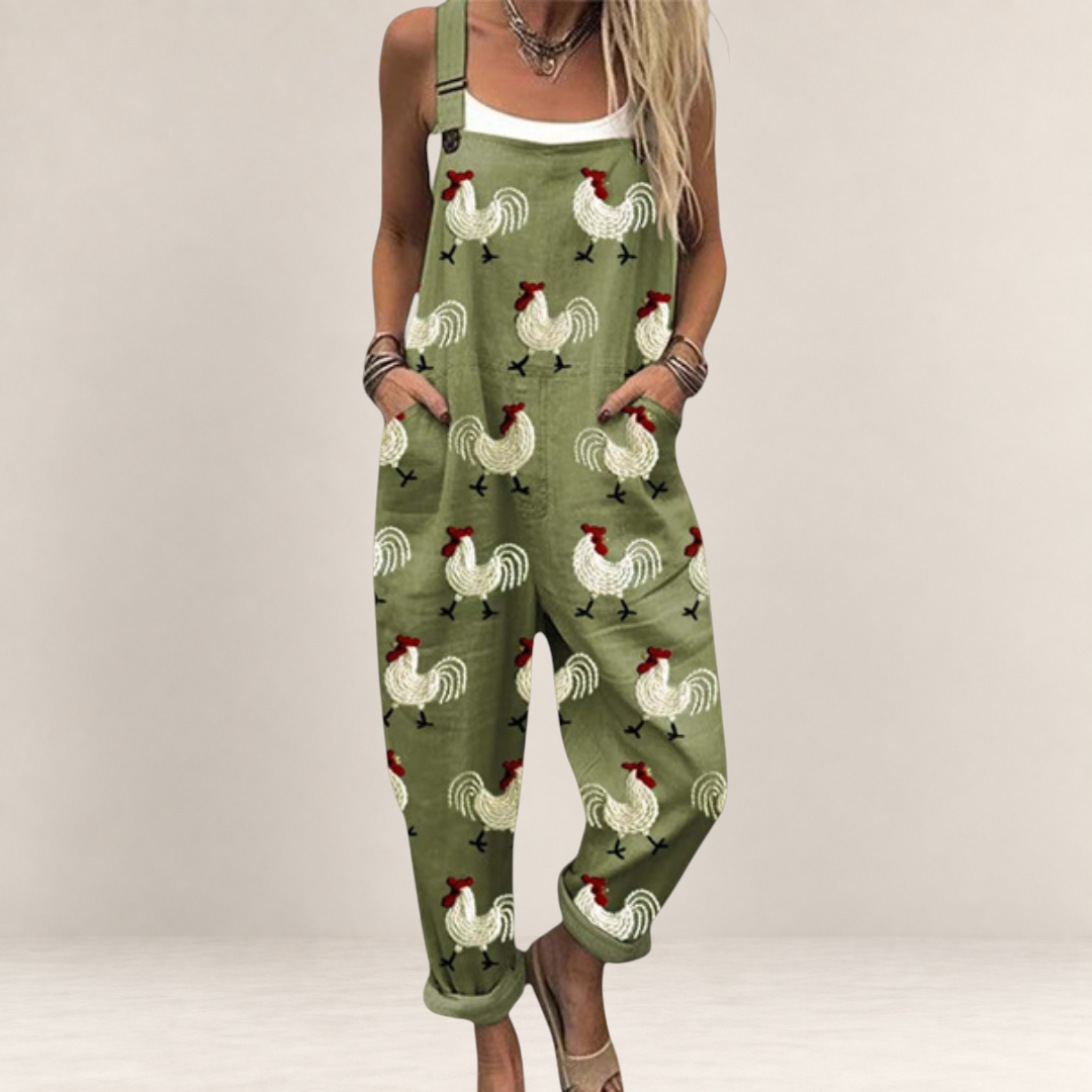 Valvet Oak House olive green printed jumpsuit with rooster pattern, loose fit, wide legs, and adjustable straps.