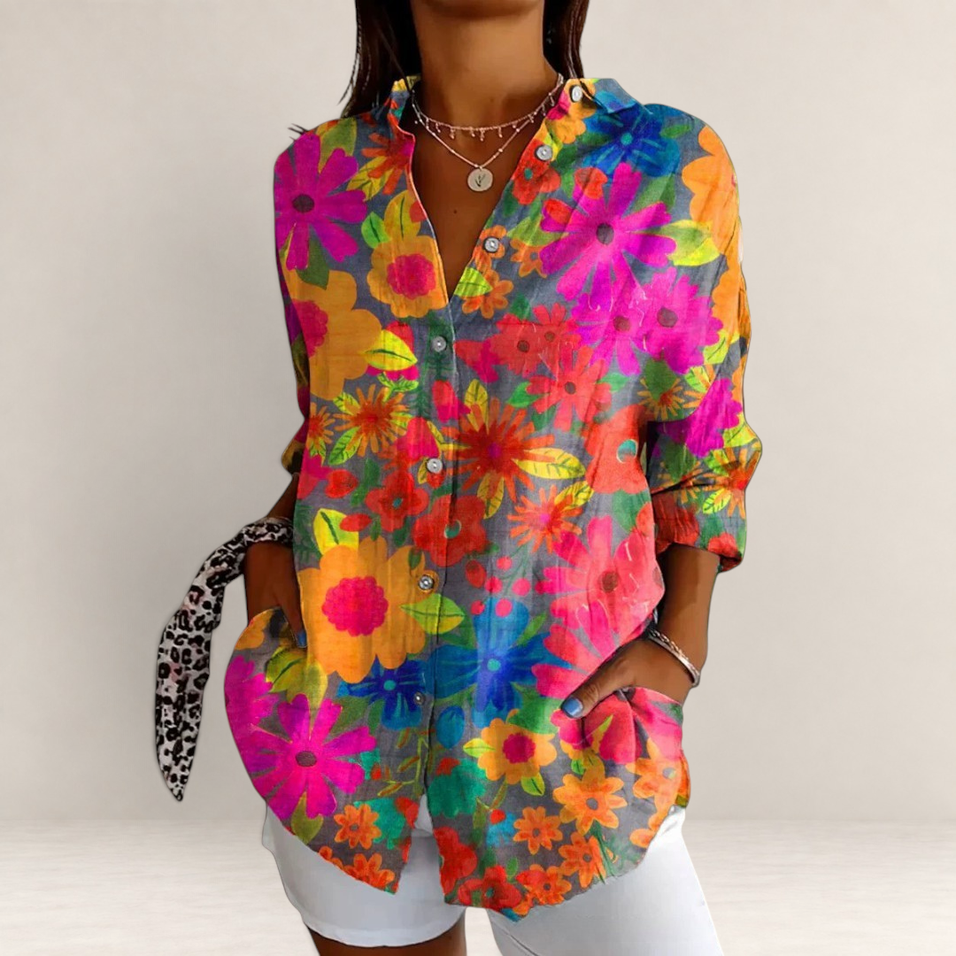 Valvet Oak House long-sleeve button-down shirt featuring a vibrant red and pink tropical floral print on a woman.