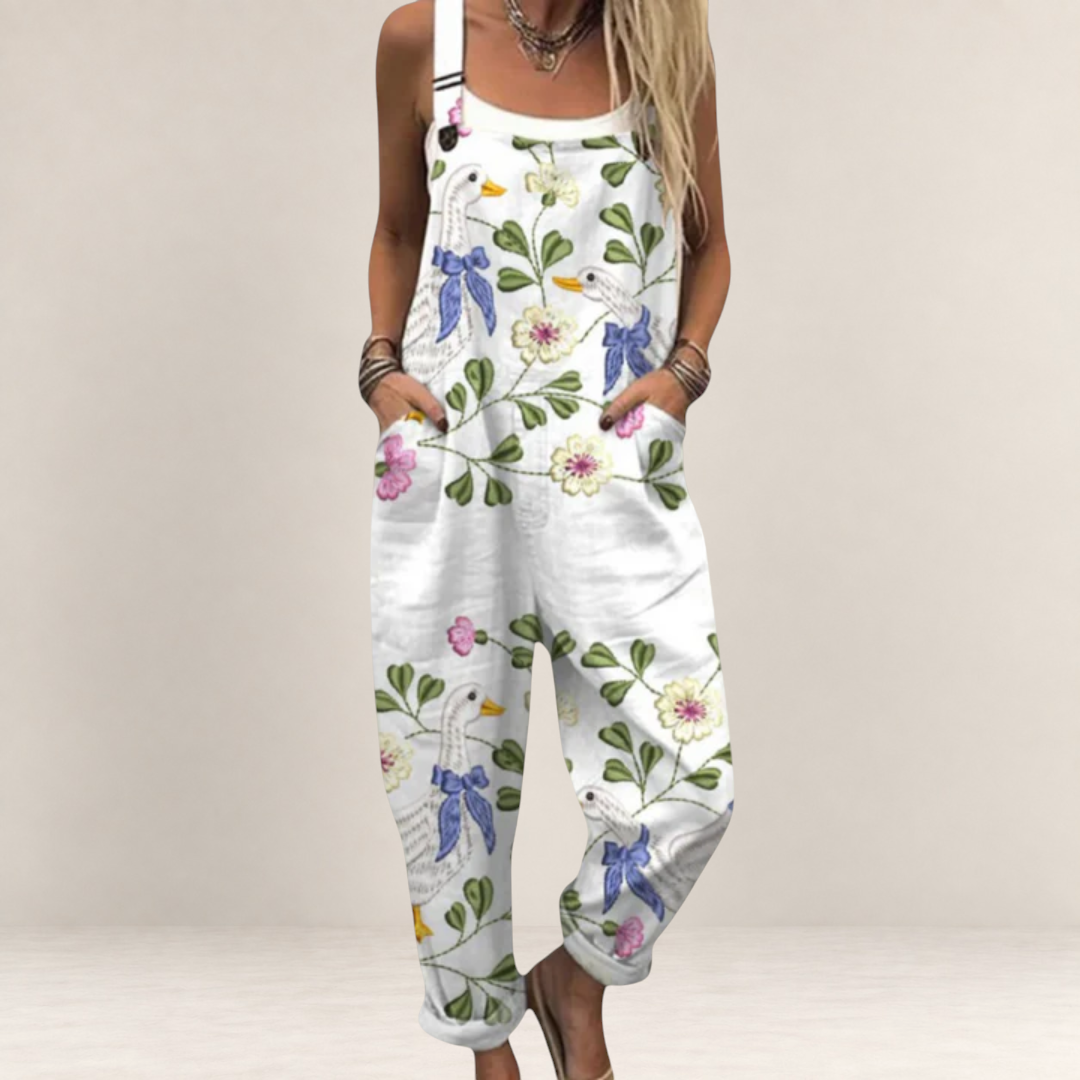 Valvet Oak House white loose-fit jumpsuit featuring a whimsical goose and floral print with adjustable straps