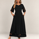 Valvet Oak House black midi dress with empire waist, sheer mesh sleeve details, and pockets on a model