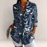 Valvet Oak House navy blue long-sleeve blouse with white floral and bird print, featuring a classic collar and pockets