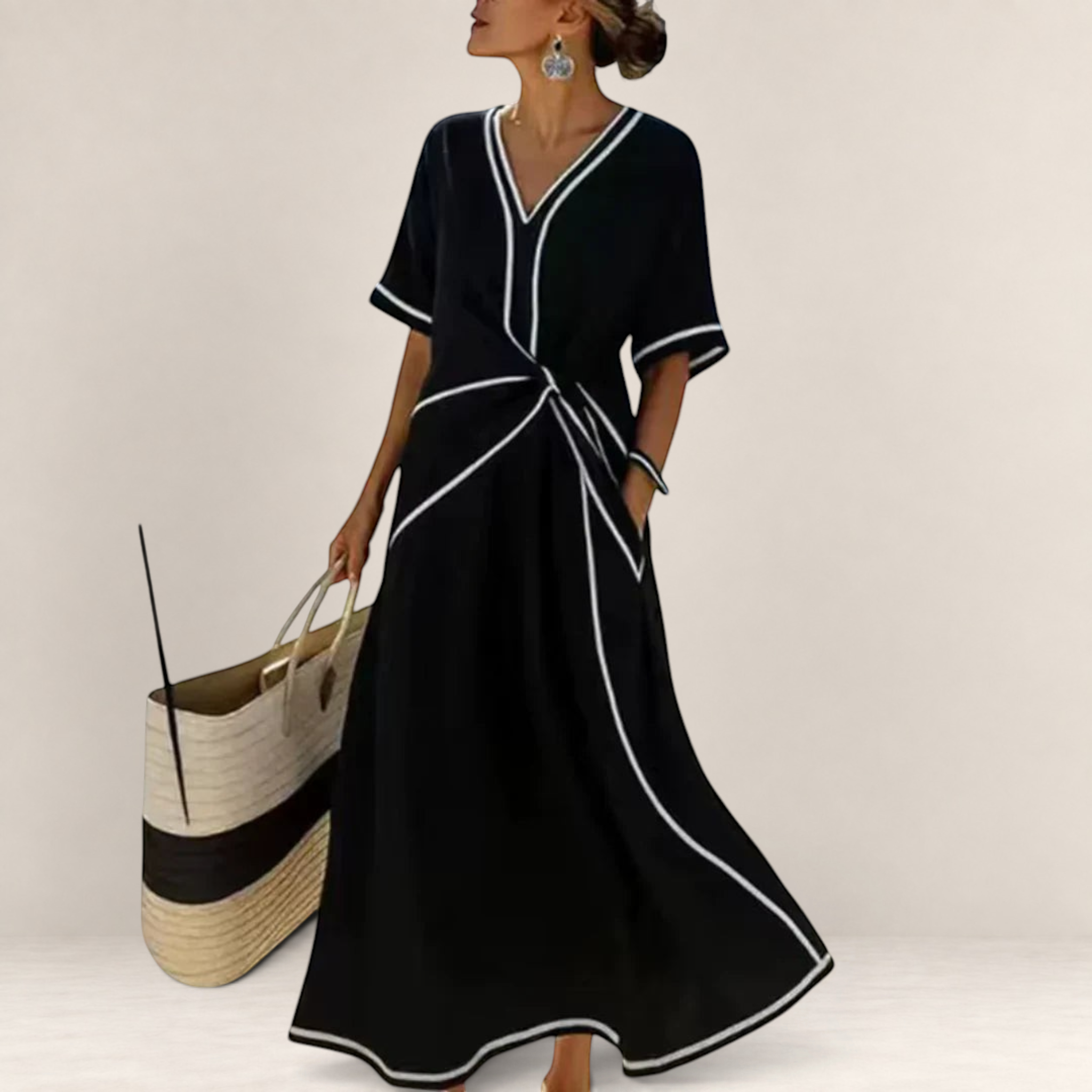 Valvet Oak House Mila black midi dress with V-neck, white contrast piping, and flattering waist detail on a terrace.