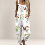 Valvet Oak House white floral print jumpsuit with wide legs, adjustable straps, and side pockets on a woman.