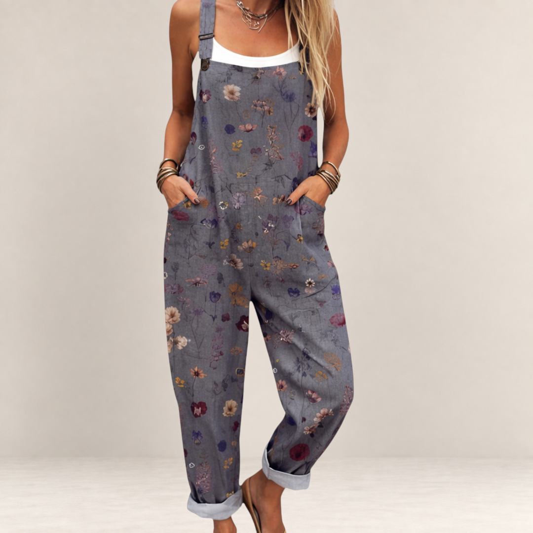 Valvet Oak House grey floral print loose-fit jumpsuit with wide legs and adjustable straps on a woman