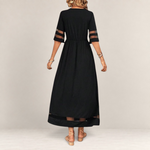 Valvet Oak House black midi dress with sheer mesh sleeve and hem panels, featuring an empire waist and flowing fit.