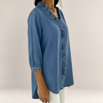 Valvet Oak House blue denim blouse with a ruffled V-neckline and three-quarter sleeves on a model
