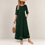 Valvet Oak House dark green midi dress with empire waist, sheer mesh sleeve details, and pockets on a model