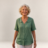 Valvet Oak House Pietra green cotton blouse with a scalloped collar worn by a smiling mature woman