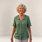 Valvet Oak House Pietra green cotton blouse with a scalloped collar worn by a smiling woman against a neutral wall